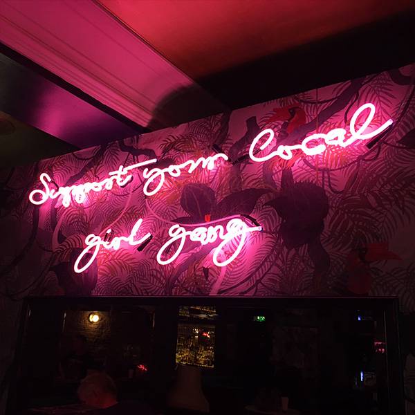 Neon light writing pink support your local girl gang
