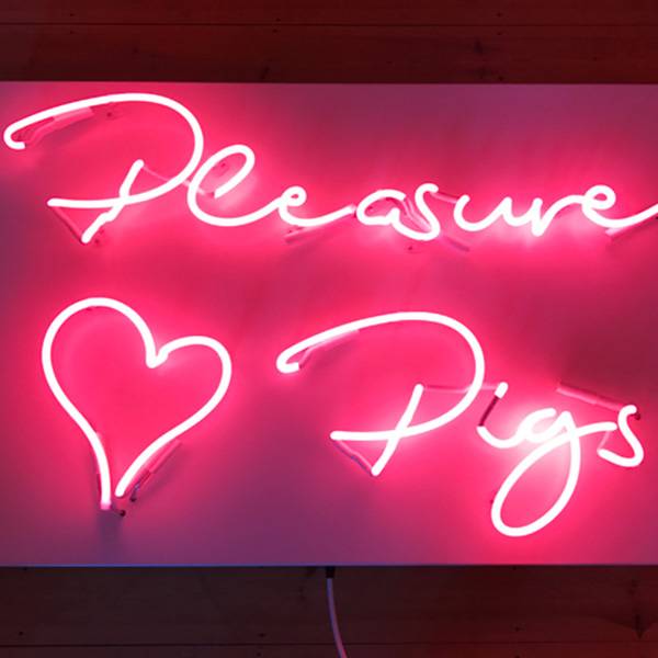 Neon light writing pink pleasure pigs