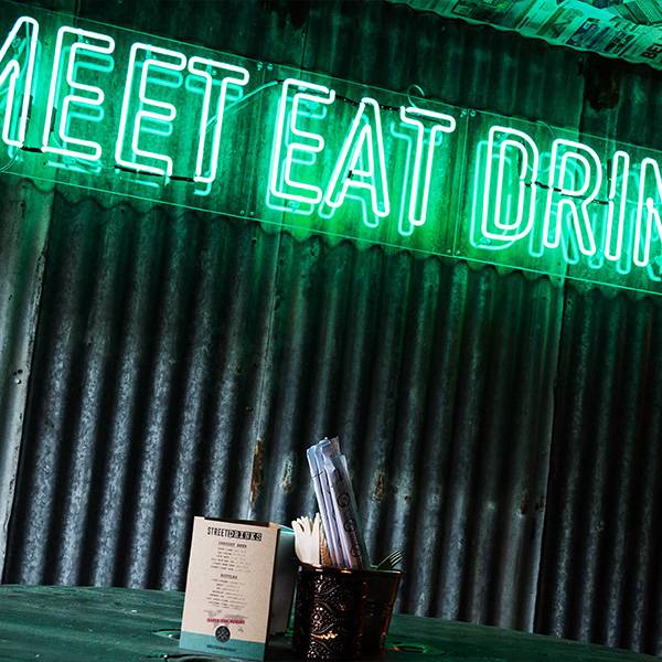 Neon light sign green meet eat drink