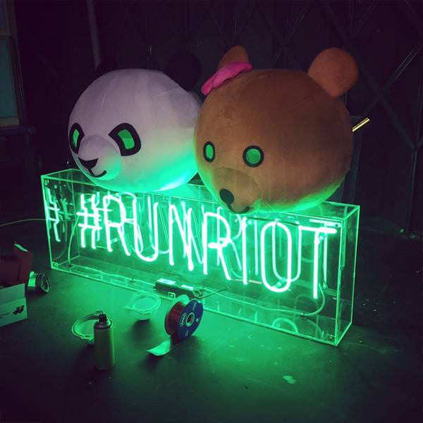 Neon light sign green run riot