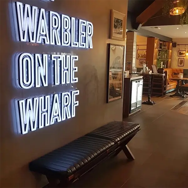 neon sign warbler on the wharf