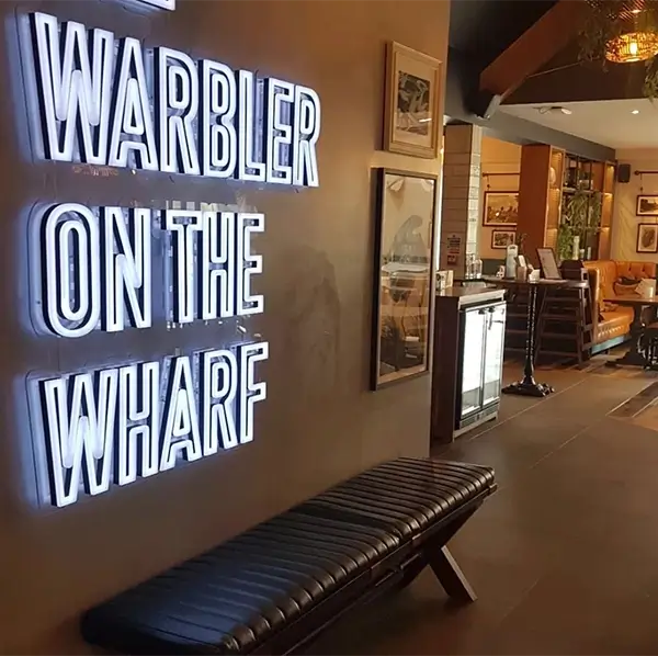 restaurant sign for warbler on the wharf