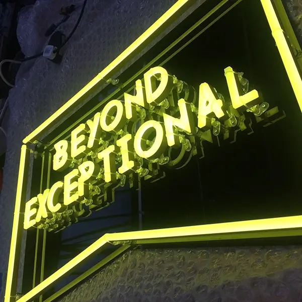 yellow led neon sign in workshop